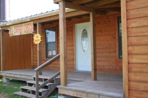 front porch and deck on ormeida's custom-built classic texas cabin model