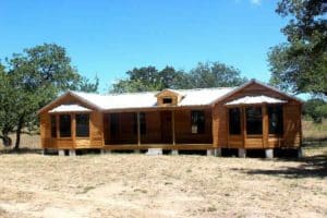 side view of a custom cabin built in texas by ormeida with large windows