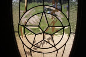 decorative glass on a custom cabin's front door with a star in the middle