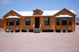 side view of a custom cabin built in texas by ormeida with large windows