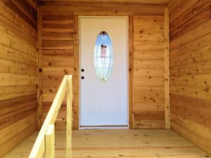 white door in the entryway of a custom texas cabin built by ormeida