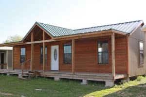 custom-built colorado cabin from ormeida in texas with one level, four front-facing windows, and a vaulted entryway