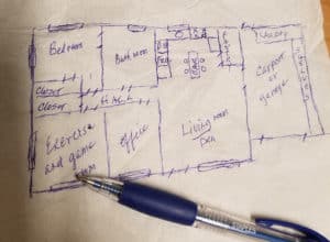 a proposed custom floorplan for a cabin in texas drawn on a napking in blue ink