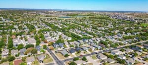 Aerial view of suburban neighborhoods in Edinburg, TX surrounded by greenery and open land
